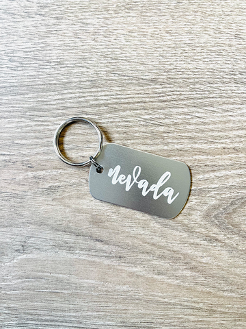Cursive Nevada Metal Keychain